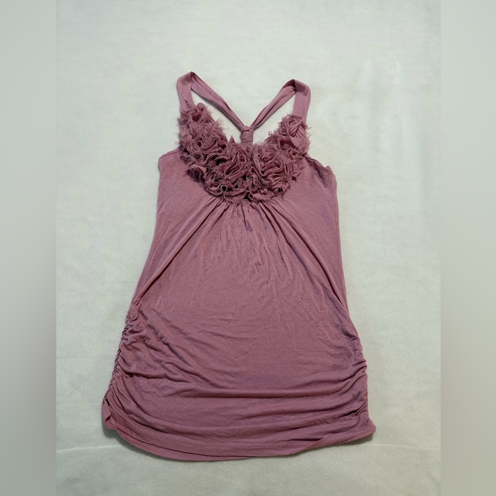 Light Pink top with flower puff in the top and crisscrooss back